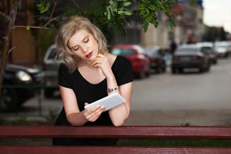Young woman holding a digital tablet computerの写真素材