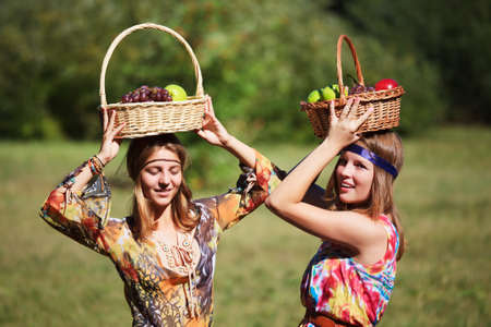 Young girls with a fruit basketsの写真素材