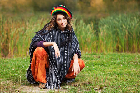 Young rastafarian woman in autumn parkの写真素材