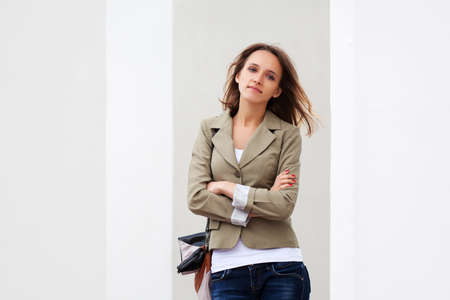 Young woman against a white wallの写真素材