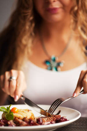 Female hand with a dinner at restaurantの写真素材