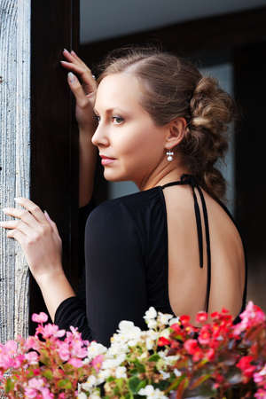 Sad beautiful woman on the porchの写真素材