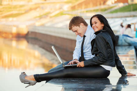 Young business couple using laptop の写真素材