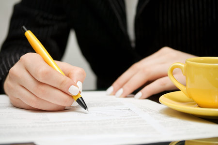 Female hands signing contract