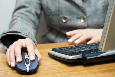 Female hand holding computer mouseの写真素材