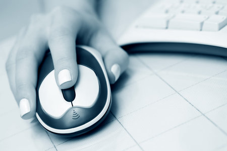 Female hand using computer mouse