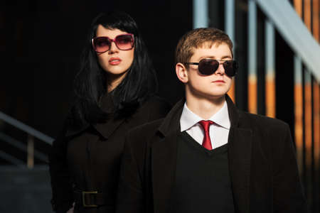 Young business couple against office buildingの写真素材