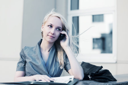 Young business woman calling on the cell phone