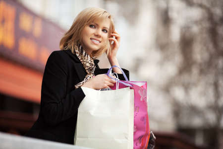 Happy young woman with shopping bags の写真素材