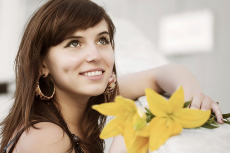 Happy young woman with a flowersの写真素材