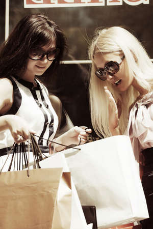 Two young women with shopping bags の写真素材