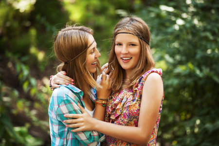 Two happy young girls in a summer forestの写真素材