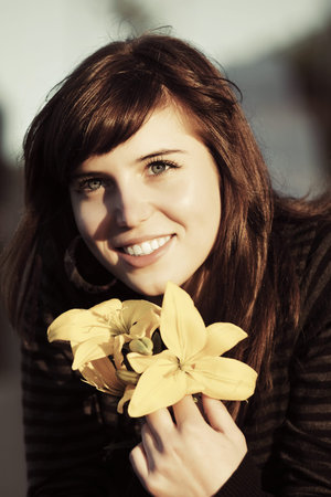 Happy young woman with a flowersの写真素材