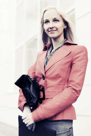 Young fashion business woman against office building の写真素材