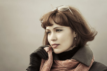 Sad fashion woman in red scarf outdoorの写真素材