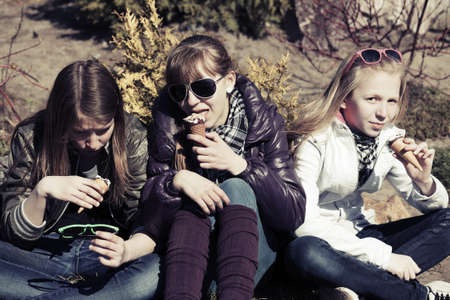 Teenage girls eating an ice creamの写真素材