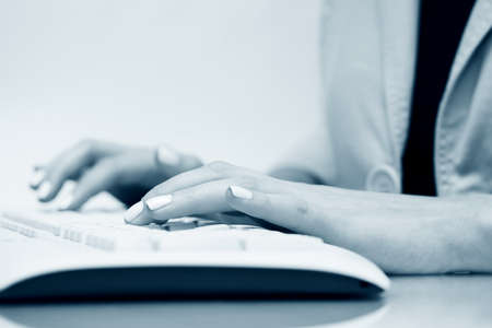 Female hands typing on computer keyboardの写真素材