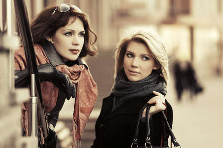 Two happy young fashion women on the city streetの写真素材