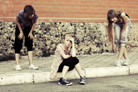 Teenage girls in conflict at the school buildingの写真素材