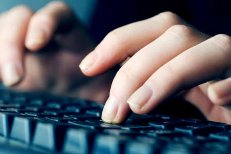 Female hands typing on computer keyboardの写真素材