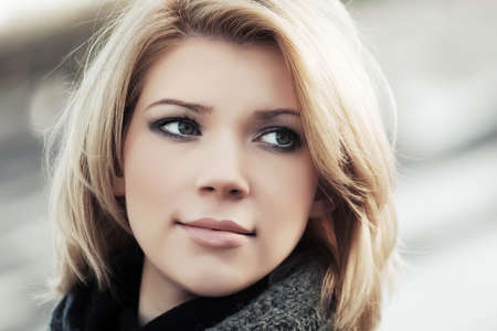 Portrait of happy blond woman outdoorの写真素材