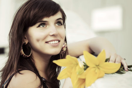 Happy young woman with a flowersの写真素材