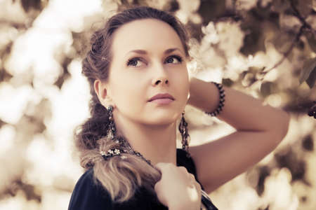 Portrait of happy beautiful fashion woman on natureの写真素材