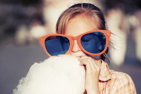 Teen girl eating cotton candy
