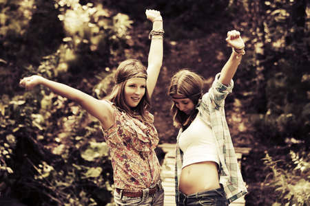Two happy teen girls in a summer forestの写真素材