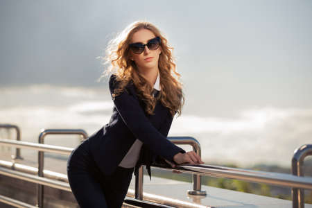 Young fashion woman in sunglasses on the city streetの写真素材