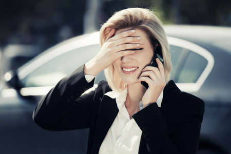 Young business woman calling on the cell phoneの写真素材