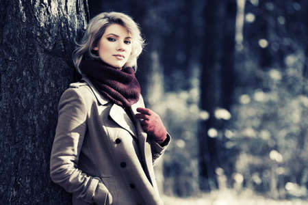 Young blond fashion woman in autumn forestの写真素材