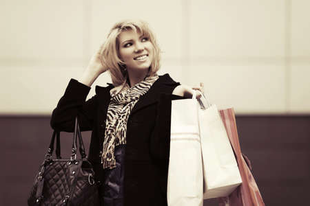 Happy young fashion woman with shopping bagsの写真素材