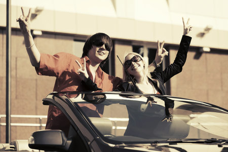 Happy young couple in the convertible car