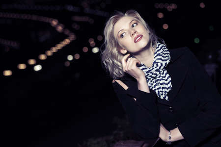Young blond fashion woman on the night city streetの写真素材