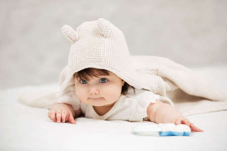 Portrait of baby girl crawling on blanket indoorsの写真素材