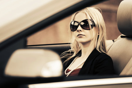 Young fashion woman driving convertible car