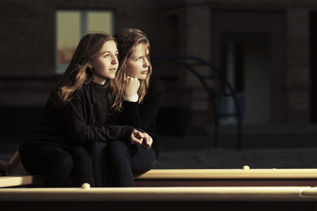 Two happy teen girls on the playground
