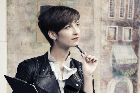 Young fashion business woman with clipboardの写真素材