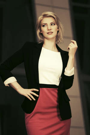 Young fashion business woman walking on city streetの写真素材