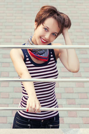 Happy young fashion woman on city streetの写真素材