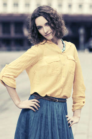 Happy young fashion woman with curly hairs outdoorの写真素材