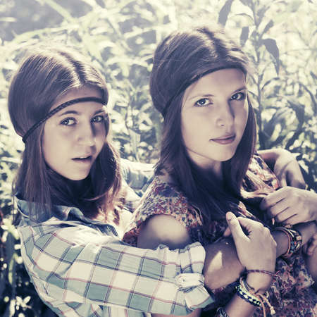 Two happy teen girls in a summer forestの写真素材