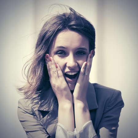 Happy young fashion woman walking on city streetの写真素材