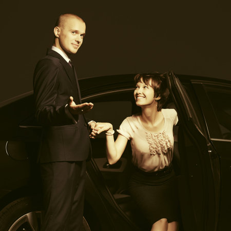 Happy young fashion couple in a car