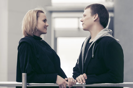 Happy young couple talking in a city street