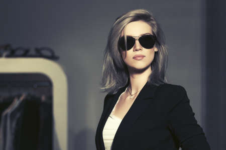 Young fashion blond woman in sunglasses in the mall interiorの写真素材