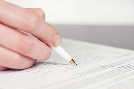 Business woman signing contractの写真素材