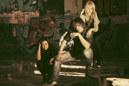 Young fashion man and women. Stylish trendy male and female models at abandoned apartmentの写真素材