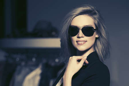 Young fashion blond woman in sunglasses in the mall interiorの写真素材